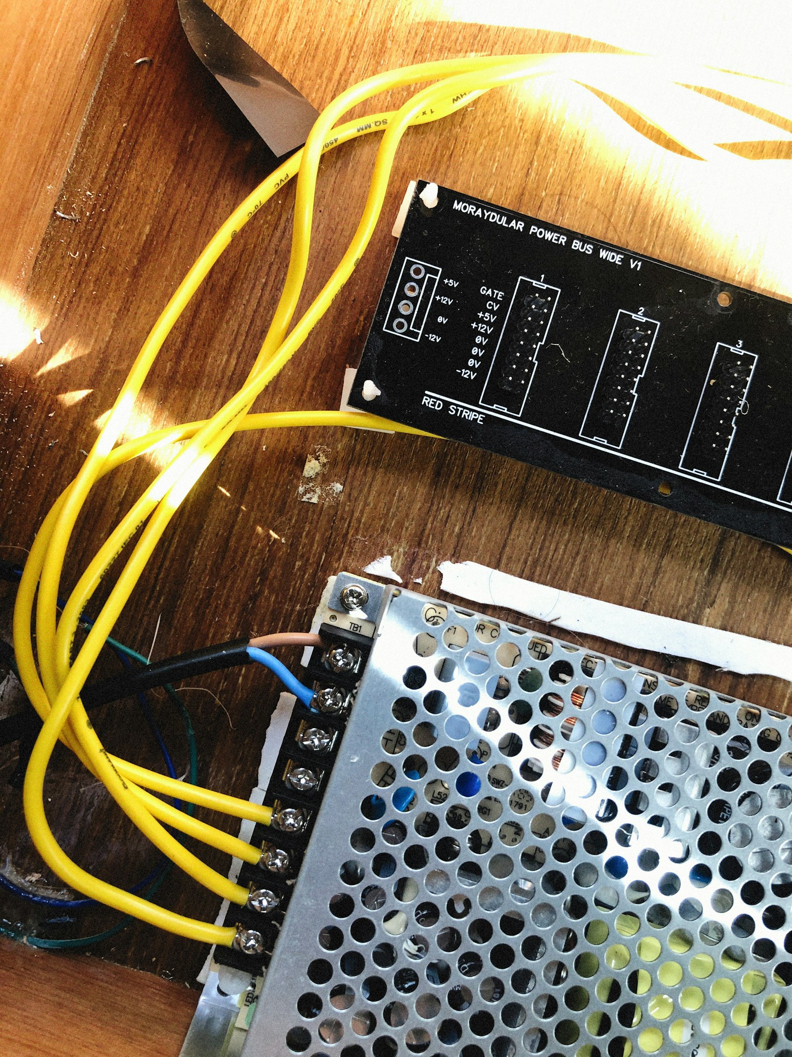 Wires and a power supply on a wood bench